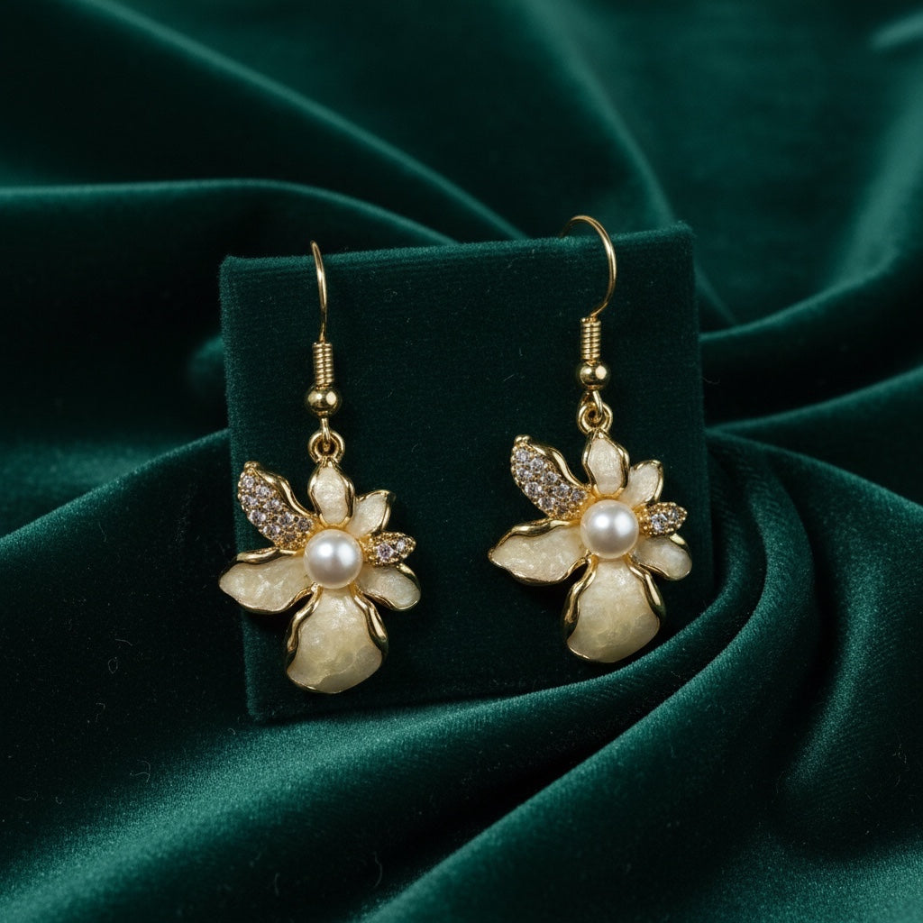 Charmluna floral hook earrings featuring mother of pearl petals, crystal accents, and a central pearl on gold-tone wire.