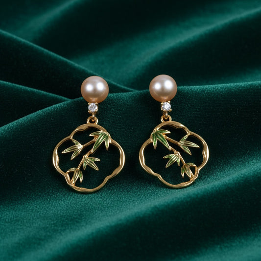Charmluna gold-tone drop earrings featuring green enamel bamboo motifs, lustrous pearls, and sparkling cubic zirconia.