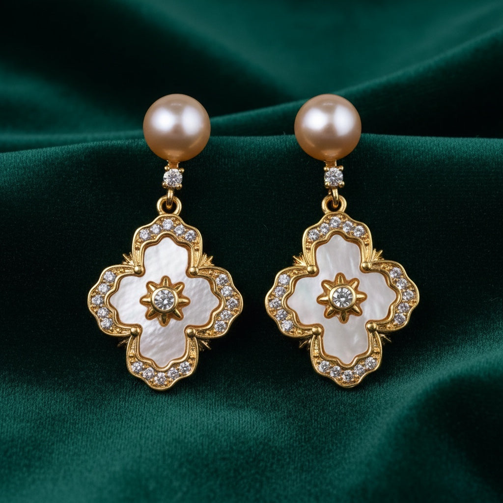Charmluna gold quatrefoil drop earrings featuring champagne pearls, mother-of-pearl inlay, and sparkling crystal accents.