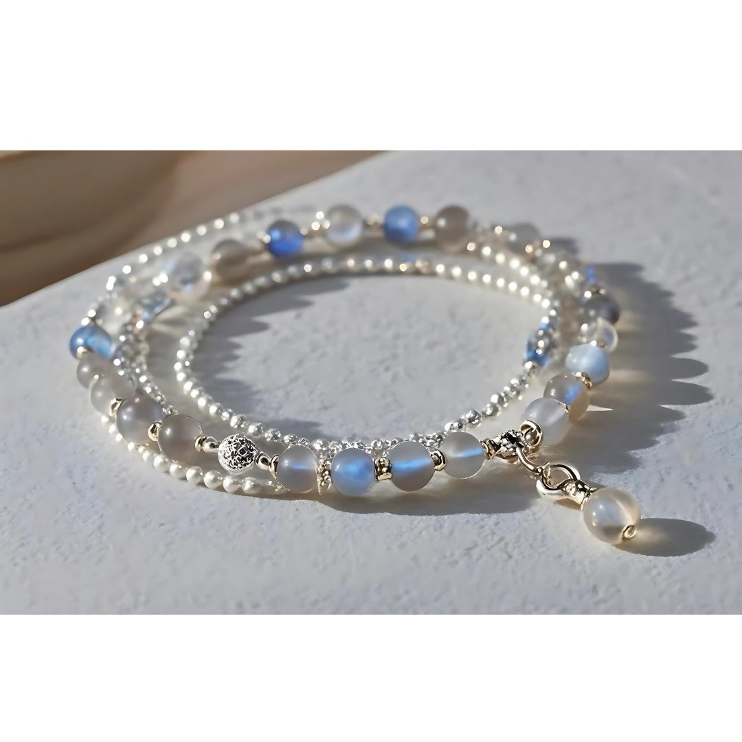 Charmluna layered beaded bracelet featuring moonstone, freshwater pearls, and a delicate silver drop charm.