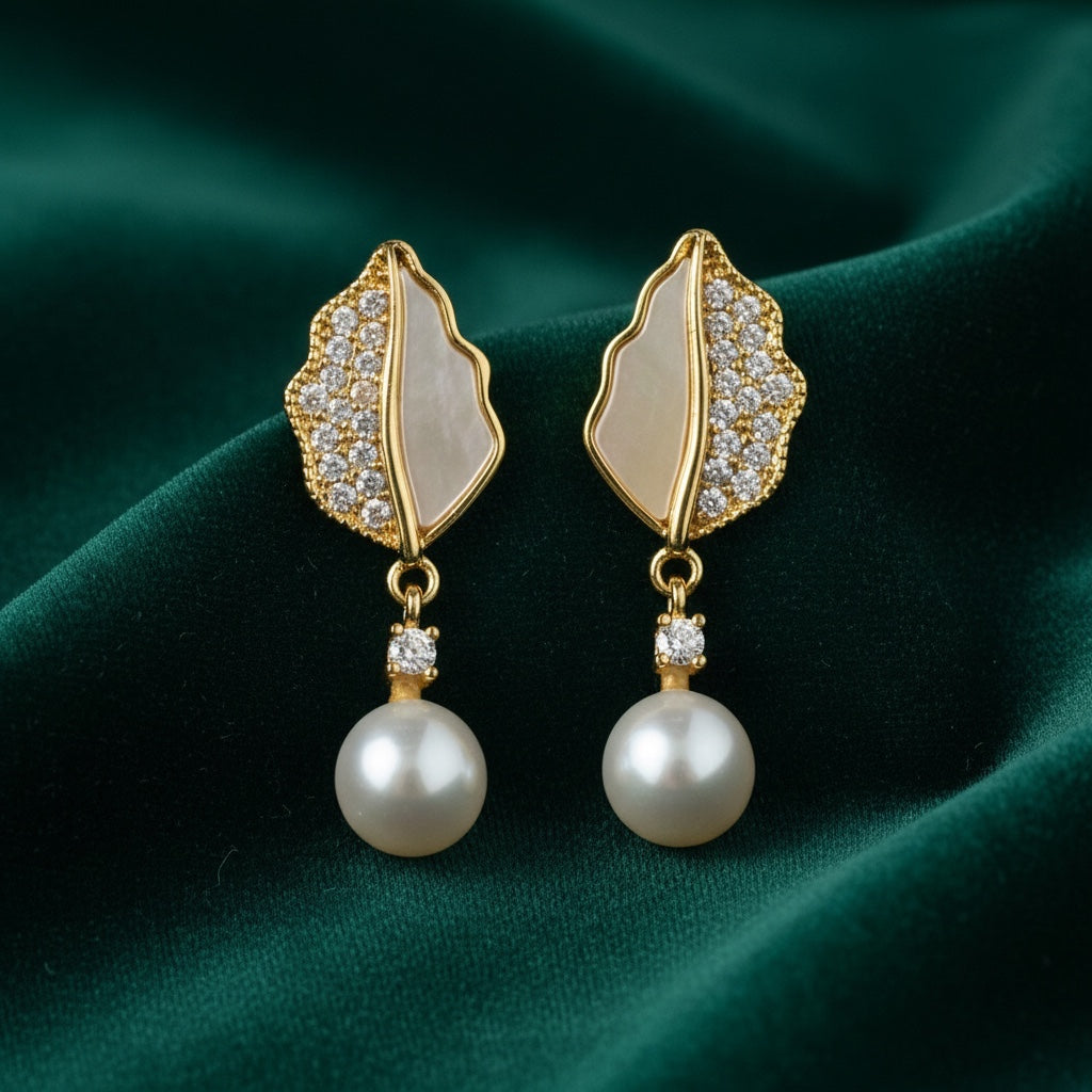 Charmluna gold-tone leaf drop earrings with mother-of-pearl inlay, cubic zirconia pavé, and dangling faux pearls.
