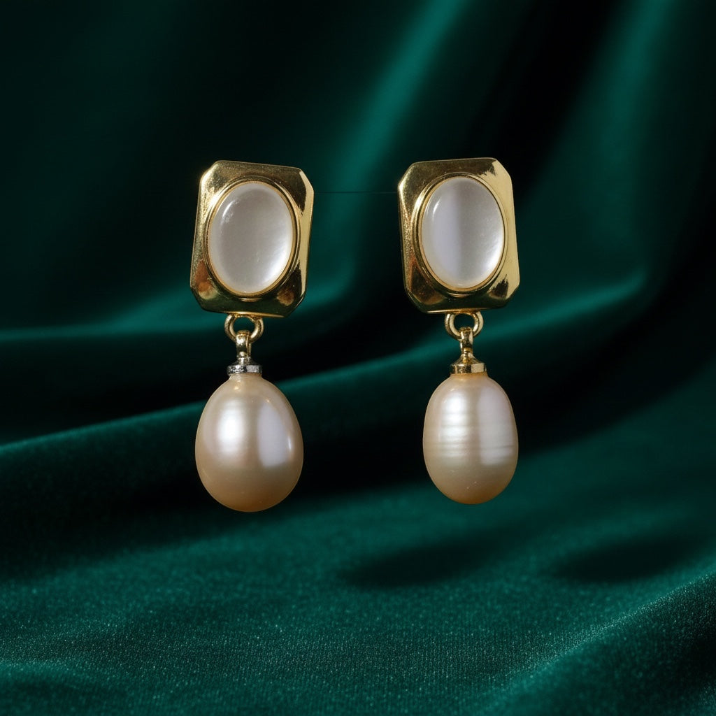 Charmluna square gold-tone earrings with oval mother of pearl centers and dangling round pearl drops on green silk.